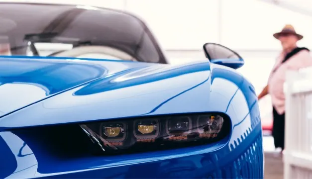Flawless factory paint finish on a blue sports car